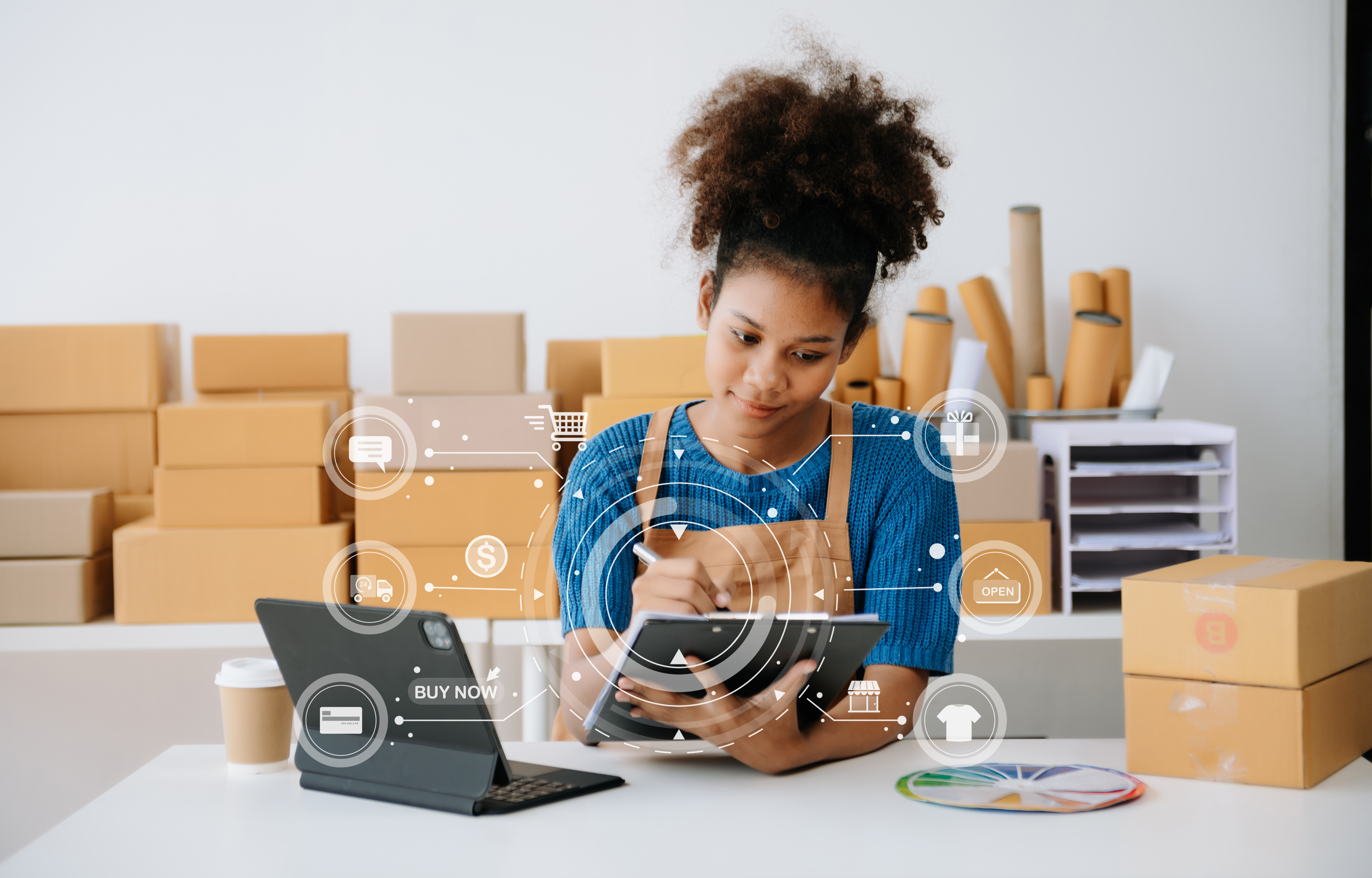 Young woman holding a smartphone next to a tablet showing payment success, a credit card, and a yellow parcel box.